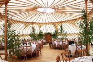 yorkshire-yurts-50ft-Yurt-round-tables-cross-back-chairs